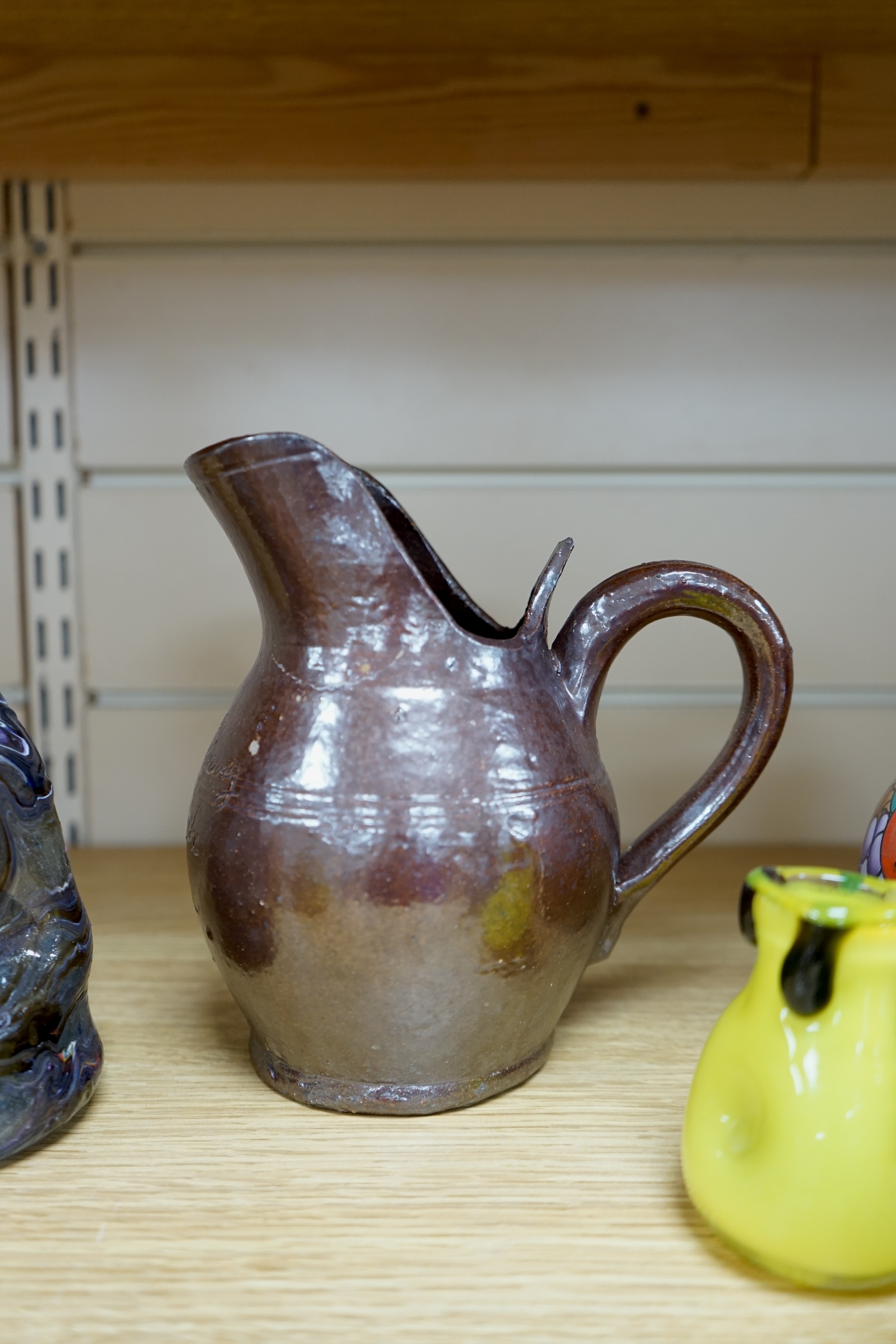 Pottery and glassware to include hand blown vases, a miniature porcelain pedestal dish and a stoneware jug, largest 17cm high. Condition - fair, some chips